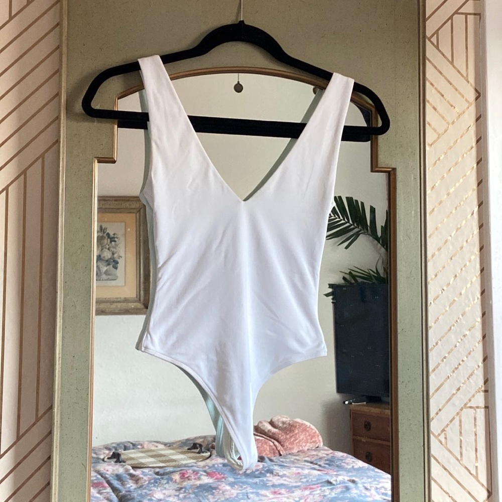 Babaton white v-neck bodysuit from Aritzia